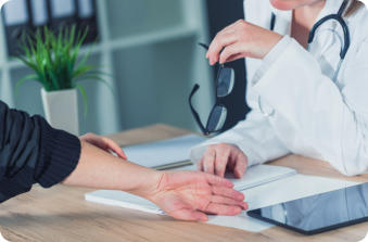 A female patient shows a female doctor where she is having pain in her wrist.