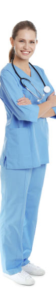 A young medical assistant wearing scrubs and a stethescope stands looking at the camera and smiling