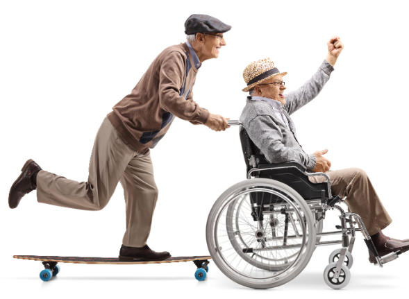 An old man riding a skateboard is pushing another old man in a wheelchair. They are both wearing jaunty hats and seem to be having a lot of fun.