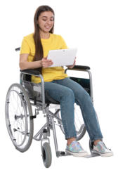 A young woman wearing jeans and a tshirt is sitting in a wheelchair looking at a tablet she is holding in her hands.