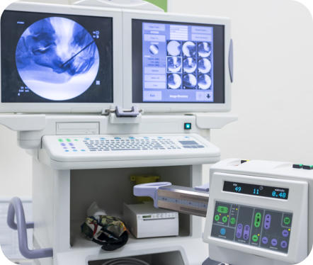 A fluoroscopy machine shows images of an arthrography procedure.