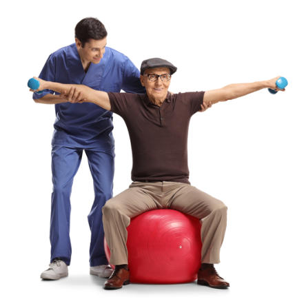 An elderly man sits on an exercise ball holding his arms straight out to his sides, and holding small dumbbells. A physical therapist is assisting him.