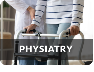 A medical professional assists a young woman in using a walker.