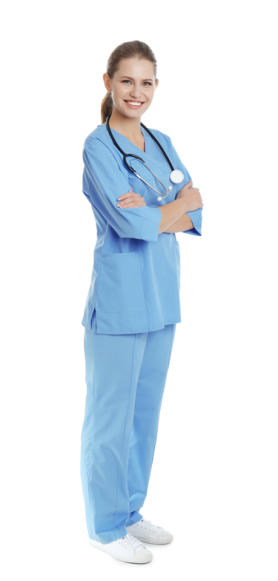 A young medical assistant wearing scrubs and a stethescope stands looking at the camera and smiling